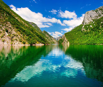 Komani Lake with green mountains in North Albania