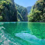 Koman Lake with emerald waters and green mountains