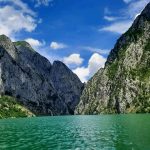 Koman Lake with big mountains and clear blue sky