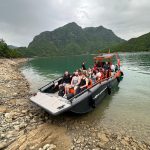 North Albania Boat filled with tourists docking at Berisha River camping location in Albania.