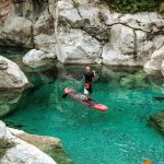 Tourist canoeing on Shala River surrounded by mountain rocks