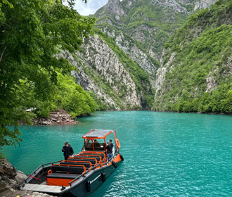 Tour boat docked on Komani Lake in North Albania