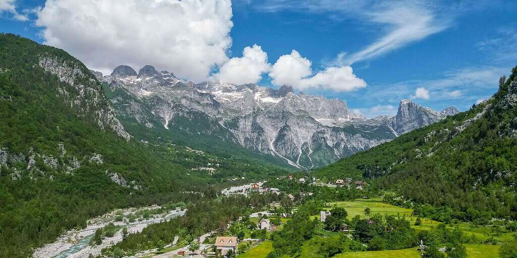 Theth valley village Albania with traditional houses river and limestone mountain peaks Albanian Alps