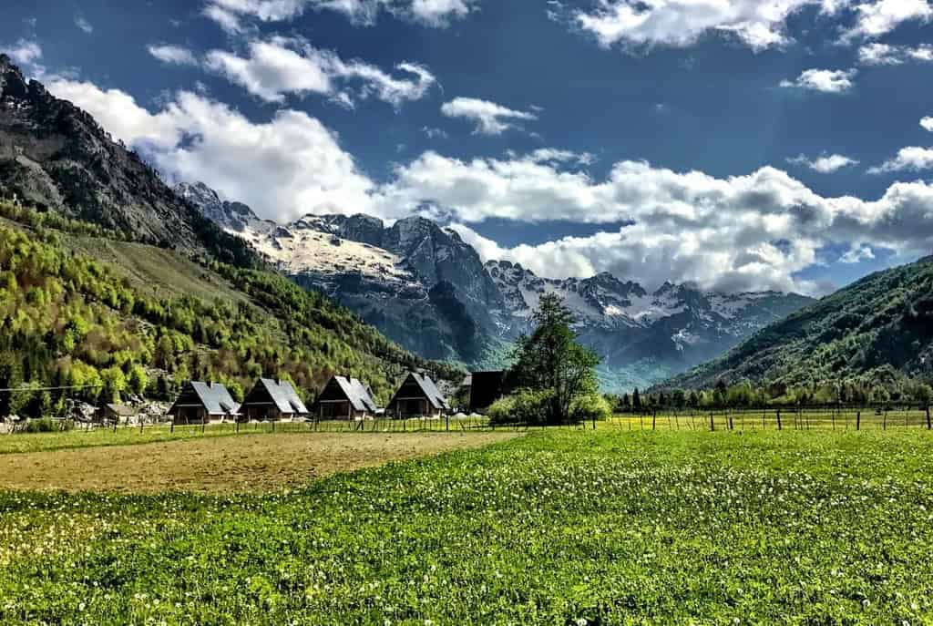Valbona valley Albania guesthouses traditional accommodation green meadow wildflowers limestone mountains Albanian Alps