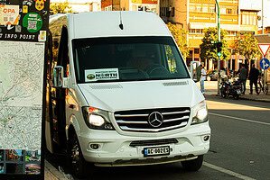 White Mercedes-Benz Sprinter minibus with North Albania Boat partner sticker on the windscreen parked on a street in Shkodër city centre, Albania, ready for the Shala River day tour departure