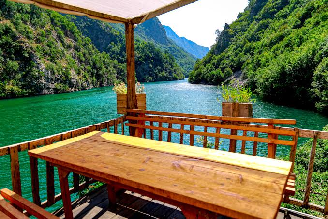 Traditional riverside restaurant overlooking the turquoise waters of Shala River, Albania