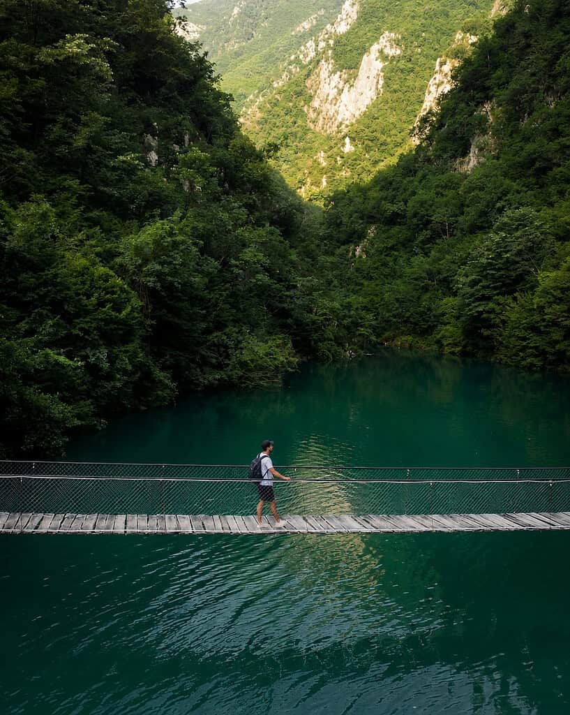 Suspension bridge overlooking the turquoise waters of Shala River in northern Albania.