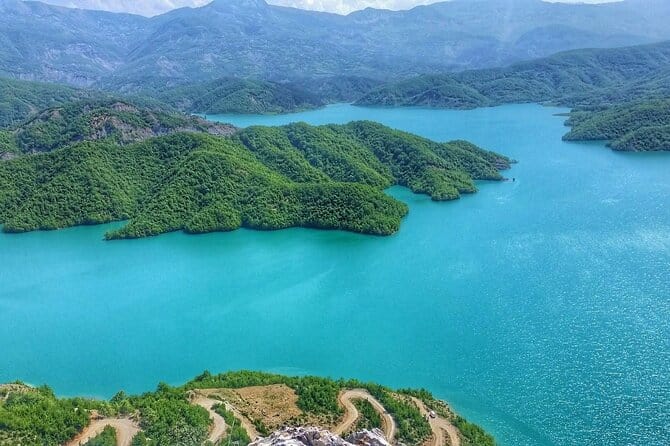 Aerial view of turquoise Bovilla Lake surrounded by green hills near Tirana, Albania