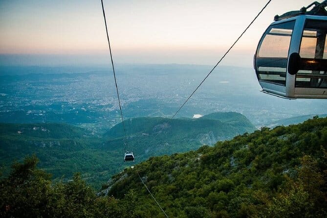 Dajti Express cable car above green hills with Tirana visible in the valley below