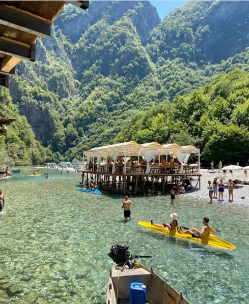 Shala River beach with kayak and riverside restaurant in Albania