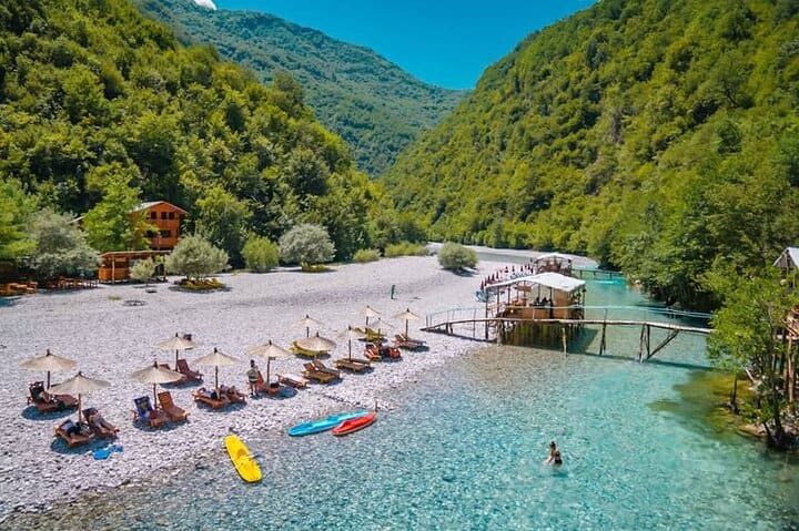 Shala River beach with kayaks and clear water in Albania