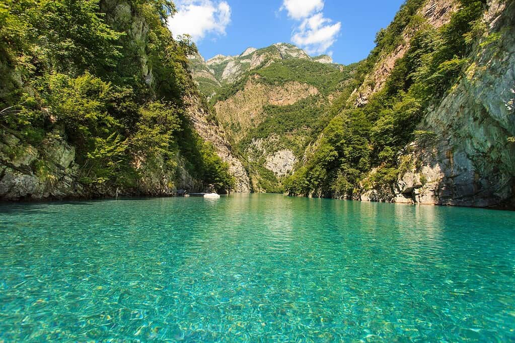 Clear turquoise water of Shala River canyon between limestone cliffs, Albania