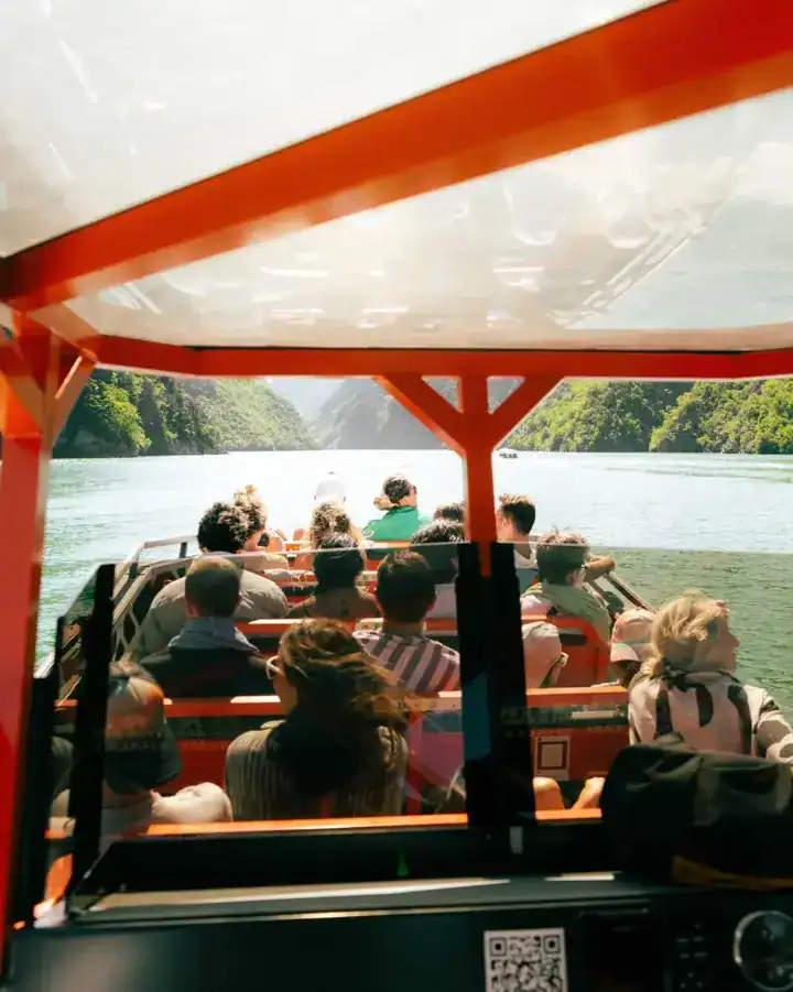 Passengers on board a boat crossing Komani Lake, Albania