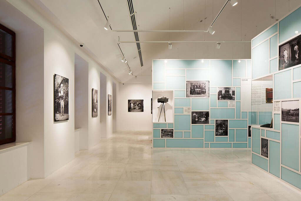 Gallery of the Marubi National Museum of Photography with historic black-and-white prints and an antique camera