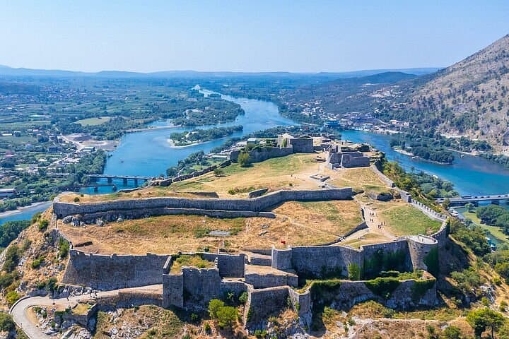 Aerial view of Rozafa Castle on its hilltop above rivers and bridges near Shkoder, Albania