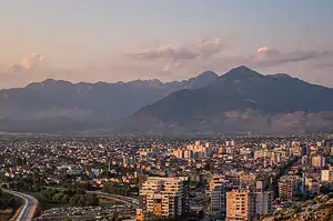 Shkoder city skyline at sunset with the Albanian Alps rising behind the rooftops